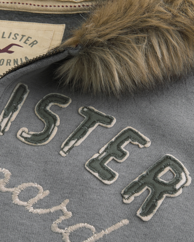 kapuzenpullover mit reißverschluss und logo besetzt mit kunstpelzbesatz und reißverschluss logo-besatz aus kunstpelz